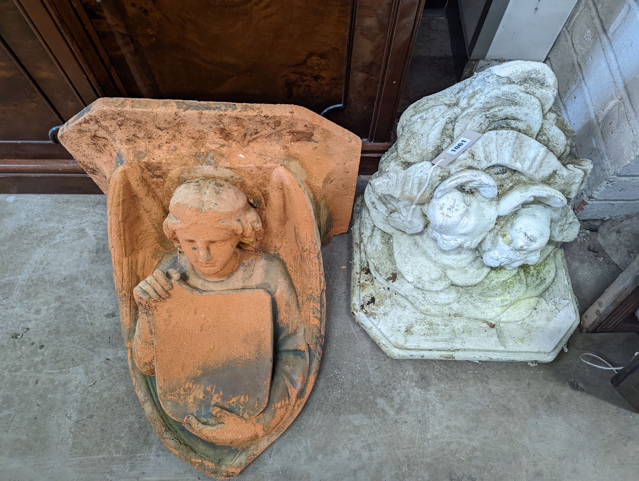 Two reconstituted stone and terracotta garden wall brackets, larger width 44cm, height 44cm